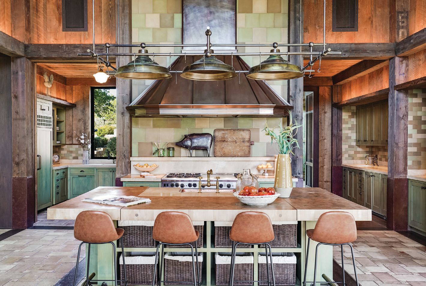 The idyllic kitchen introduces contrasting colors and farmhouse-inspired decor. PHOTO BY CAROLINE PEEL AND AERIAL CANVAS