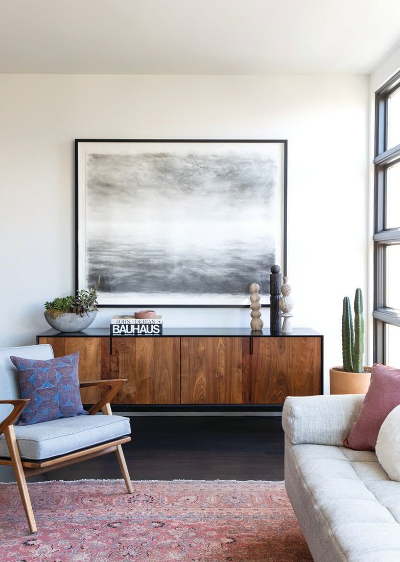 Hung over a credenza by L.A.-based Croft House, “Over Seas” by British painter SarahBold commands attention in the living room. PHOTOGRAPHED BY BESS FRIDAY