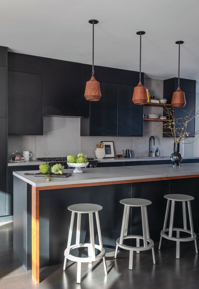Like the rest of the home, the kitchen contains a mix of black and white elementsmixed with earthy textures. The Ikea cabinets are equipped with Semihandmade doors in Supermatte Black Slab, while the counters and backsplash are by Concrete Interiors. PHOTOGRAPHED BY BESS FRIDAY
