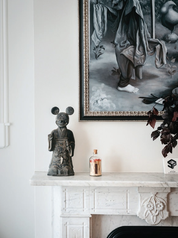 An “Emperor Mickey” sculpture by Lizabeth Eva Rossof decorates the living room mantel. PHOTOGRAPH BY CHRISTOPHER STARK