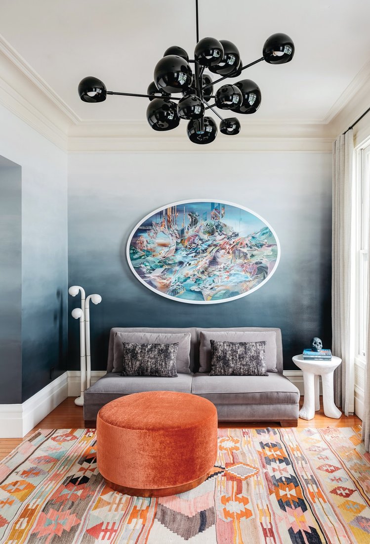 Caroline Lizarraga handpainted an intricate ombre on the upper-level study’s walls, while a David Weeks Kopra Burst chandelier and colorful piece by Mars‑1, aka Mario Martinez, add contrast PHOTOGRAPH BY CHRISTOPHER STARK