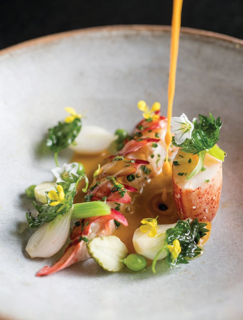 Taj Campton Place’s lobster poached in ghee with sweet onions, young peas and coastal curry ESTIATORIO ORNOS DISH PHOTO BY DAVID VARLEY