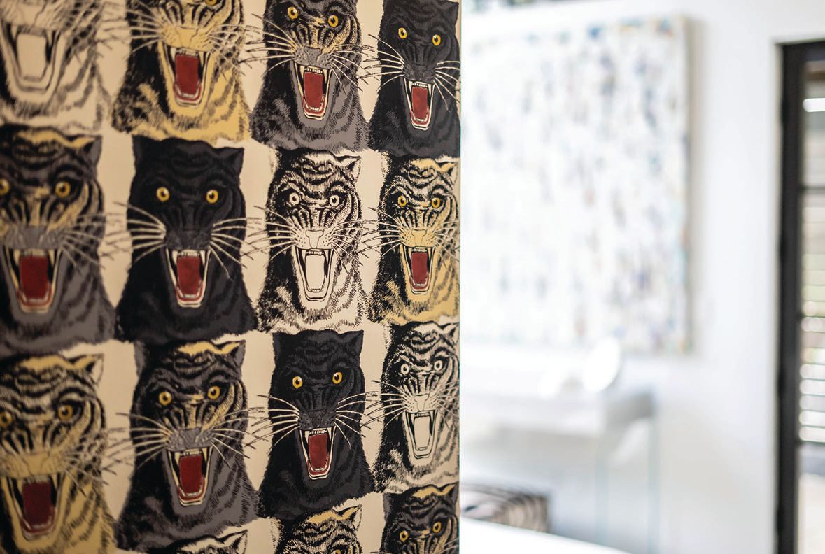 Gucci tiger wallpaper lines two strategic walls, adding a whimsical and artistic layer to the room PHOTO COURTESY OF STONES WINE