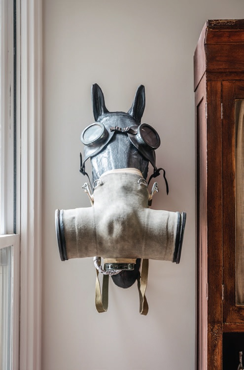 Horse head sculptures, also in the family room, wear vintage gas masks from WWI PHOTOGRAPH BY CHRISTOPHER STARK